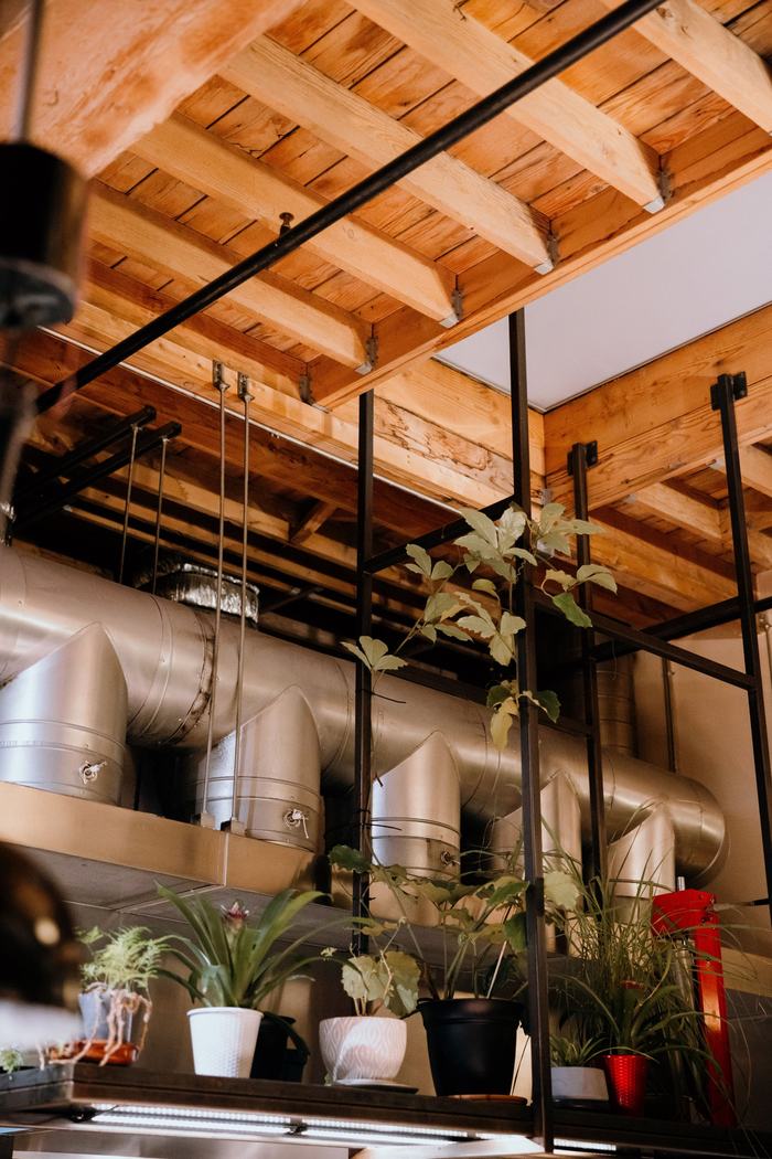 Metal ductwork run under a wood-beam ceiling