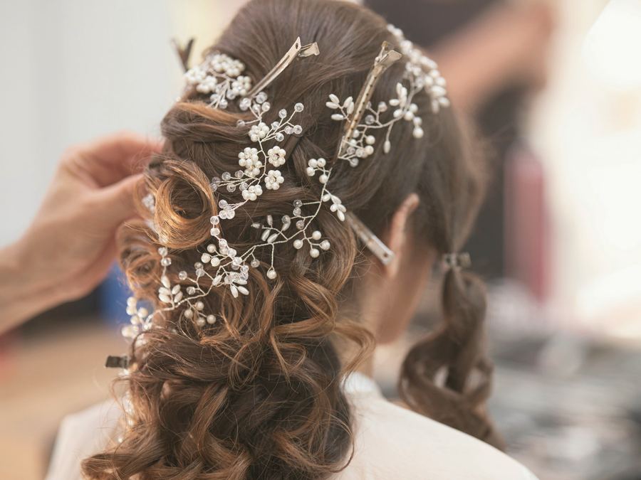 Brunette bridal curls with a pearl hair vine