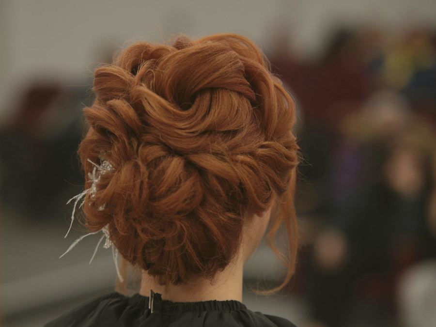 Copper red hair pinned into a twisted updo
