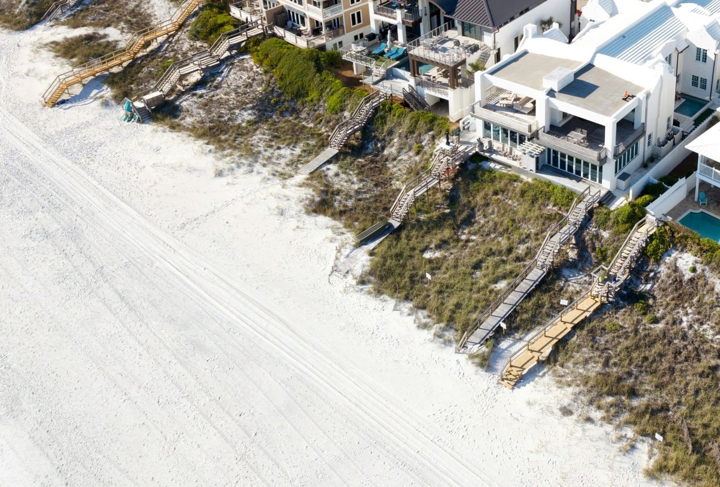 White sand beach below the dunes with boardwalks down to the water