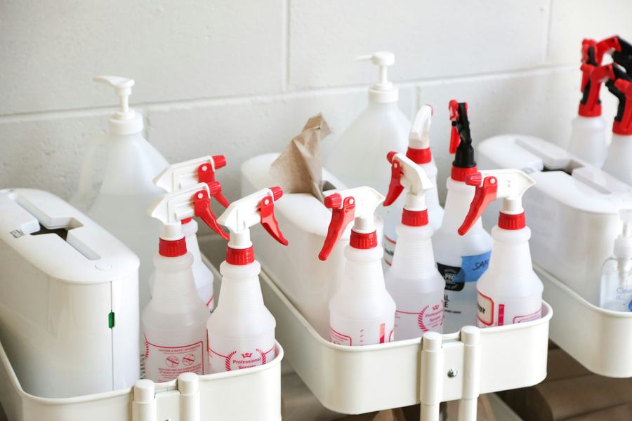 Cart of spray bottles and cleaning supplies