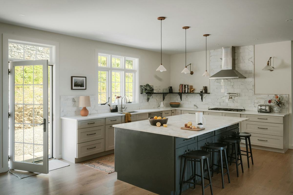 Bright clean kitchen with wiped marble counters and an island