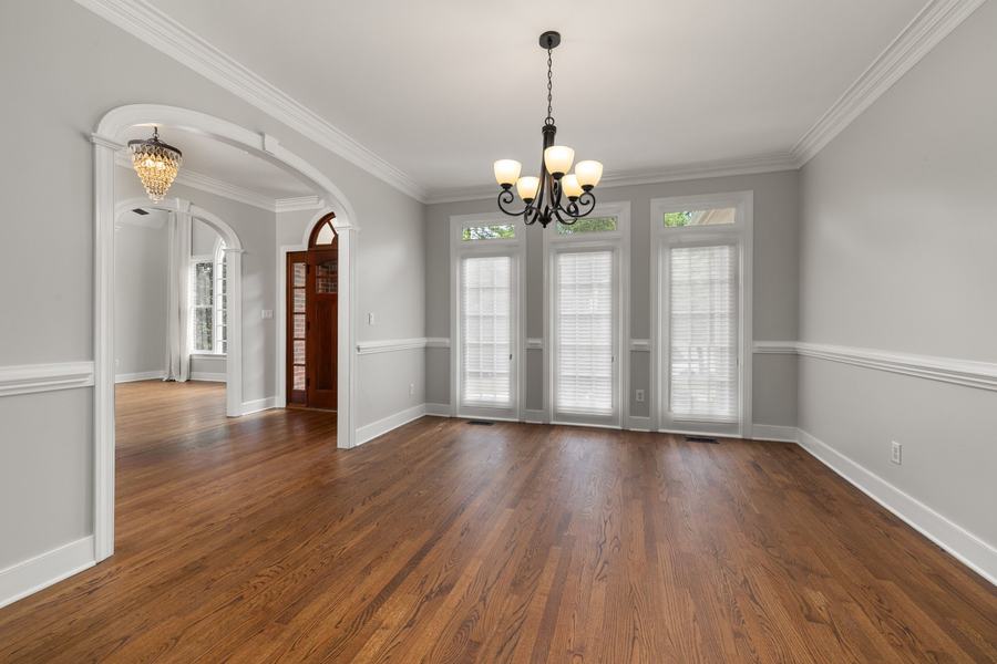 Dining room with crown molding, chair rail and arched casing