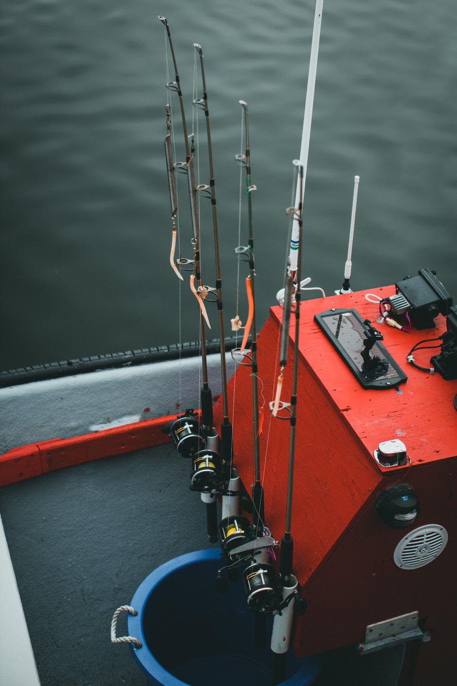 Rods and reels standing in the holders beside the boat's red console